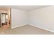 A carpeted bedroom with a view into the bathroom shows an open layout at 245 Suncrest Dr, Greenwood, IN 46143