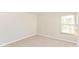 Bedroom features neutral walls, carpeted floors, a window for natural light, and standard electric outlets at 245 Suncrest Dr, Greenwood, IN 46143