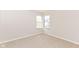 Bright bedroom with neutral carpet and two windows providing natural light at 245 Suncrest Dr, Greenwood, IN 46143