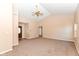 Inviting living room with vaulted ceilings, neutral carpet, and an open layout at 245 Suncrest Dr, Greenwood, IN 46143