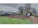 Large, fenced backyard with lawn and an outbuilding at 2617 N Temple Ave, Indianapolis, IN 46218