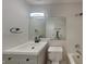 Bathroom with a white vanity, toilet and shower with black hardware at 2617 N Temple Ave, Indianapolis, IN 46218