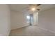 Spacious bedroom featuring neutral carpet, a ceiling fan, a window, and a closet at 2617 N Temple Ave, Indianapolis, IN 46218