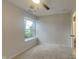 Comfortable bedroom with light walls, soft carpet, ceiling fan and a window at 2617 N Temple Ave, Indianapolis, IN 46218