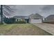 Charming one-story home featuring a well-maintained lawn, attached two-car garage, and welcoming entrance at 2617 N Temple Ave, Indianapolis, IN 46218