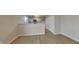 Open kitchenette area featuring white cabinets, quartz countertops, and wood-look flooring at 2617 N Temple Ave, Indianapolis, IN 46218