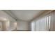 Bright living room featuring light-colored walls, wood-look flooring, and large windows with vertical blinds at 2617 N Temple Ave, Indianapolis, IN 46218