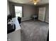 This spacious bedroom features natural light, plush carpet, and ample space for a comfortable home office setup at 298 Rocky Rd, Greenfield, IN 46140