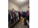 This organized walk-in closet includes plenty of hanging space and storage shelving at 298 Rocky Rd, Greenfield, IN 46140