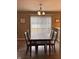 Comfortable dining area with a modern light fixture, adjacent to the kitchen, perfect for Gathering meals at 298 Rocky Rd, Greenfield, IN 46140