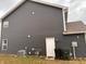 Exterior side view shows the home's siding, a convenient access door, and utility connections at 298 Rocky Rd, Greenfield, IN 46140