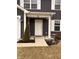 Charming home entrance with a white door and welcoming decor, complemented by a well-maintained lawn at 298 Rocky Rd, Greenfield, IN 46140