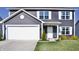 Inviting home featuring a classic design, neat landscaping, and a spacious two-car garage at 298 Rocky Rd, Greenfield, IN 46140