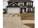 Charming two-story home featuring a two-car garage, well-maintained lawn, and classic architectural details at 298 Rocky Rd, Greenfield, IN 46140