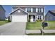 Charming two-story home with a well-manicured lawn and a two-car garage at 298 Rocky Rd, Greenfield, IN 46140