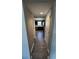 Hallway view looking into a modern kitchen with dark cabinets and stainless steel appliances at 298 Rocky Rd, Greenfield, IN 46140