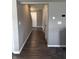 Hallway with wood-look flooring and gray walls leading to the upstairs staircase at 298 Rocky Rd, Greenfield, IN 46140