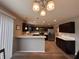 Well-lit kitchen features dark wood cabinets, stainless steel appliances, and a breakfast bar with modern finishes at 298 Rocky Rd, Greenfield, IN 46140
