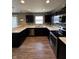 Modern kitchen with stainless steel appliances, dark cabinets, and light countertops at 298 Rocky Rd, Greenfield, IN 46140
