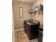 Functional laundry room with modern washer and dryer set and storage shelving at 298 Rocky Rd, Greenfield, IN 46140