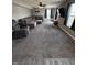 Large living room with carpet, modern ceiling fan and oversized sectional sofa at 298 Rocky Rd, Greenfield, IN 46140