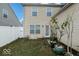 View of the house from the backyard with a white fence and small potted plants at 3432 Shepperton Blvd, Indianapolis, IN 46228