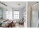 Bright bathroom with vanity, tub/shower combination, and window at 3432 Shepperton Blvd, Indianapolis, IN 46228