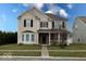 Charming two-story home featuring neutral siding, black shutters, and a welcoming front porch at 3432 Shepperton Blvd, Indianapolis, IN 46228