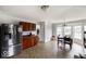Bright kitchen and dining area features stainless steel refrigerator and wooden cabinets at 3432 Shepperton Blvd, Indianapolis, IN 46228