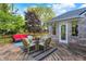 A wooden deck with red sofa, wicker chairs, table, and a patterned rug, perfect for entertaining at 37 Trotters Run, Brownsburg, IN 46112