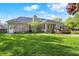 A spacious backyard features a brick house with a deck, perfect for outdoor living at 37 Trotters Run, Brownsburg, IN 46112