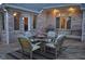 Backyard patio features a glass table with wicker chairs and an outdoor seating area at 37 Trotters Run, Brownsburg, IN 46112