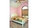 Bedroom featuring a white bedframe, arched window, pink walls and neutral carpeting at 37 Trotters Run, Brownsburg, IN 46112