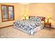 Relaxing bedroom with a patterned bedspread, neutral walls, and a large window with natural light at 37 Trotters Run, Brownsburg, IN 46112