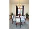 Cozy dining room featuring an elegant chandelier, floral centerpiece, and ample natural light at 37 Trotters Run, Brownsburg, IN 46112