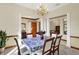 Elegant dining room with a chandelier, neutral walls, and a view of the living area at 37 Trotters Run, Brownsburg, IN 46112