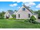 Beautiful exterior view of home showcasing the brick facade, manicured landscaping, and lush greenery at 37 Trotters Run, Brownsburg, IN 46112