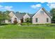 Charming brick home with a well-manicured lawn and lush landscaping creates inviting curb appeal at 37 Trotters Run, Brownsburg, IN 46112