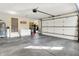 Spacious garage features a roll up door and storage, with an attached room with a door to the exterior at 37 Trotters Run, Brownsburg, IN 46112
