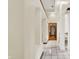 Bright hallway with tile flooring, neutral walls, and views into other areas of the home at 37 Trotters Run, Brownsburg, IN 46112