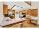 Functional kitchen with wooden cabinets, a stainless steel refrigerator, and breakfast bar seating at 37 Trotters Run, Brownsburg, IN 46112