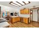 Bright eat-in kitchen boasts stainless appliances, wood cabinets, and an adjacent breakfast nook at 37 Trotters Run, Brownsburg, IN 46112