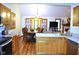 Open kitchen featuring stainless steel appliances, modern lighting, and wood floors at 37 Trotters Run, Brownsburg, IN 46112