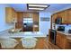 Bright kitchen showcasing stainless steel appliances, wood floors, and a center island with seating at 37 Trotters Run, Brownsburg, IN 46112