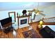 Aerial view of the living room with a fireplace, ceiling fan and a patterned rug atop the hardwood floor at 37 Trotters Run, Brownsburg, IN 46112