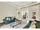 Open living area with sofas, neutral walls, and views into the dining room and foyer at 37 Trotters Run, Brownsburg, IN 46112