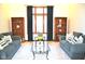 Serene living room featuring two cozy couches, decorative pillows, and warm wood bookshelves at 37 Trotters Run, Brownsburg, IN 46112