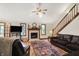 Bright living room featuring hardwood floors, fireplace, and a large comfy-looking sofa at 37 Trotters Run, Brownsburg, IN 46112