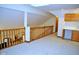 Open loft area featuring railing, carpeted floors, skylight and wet bar with wood cabinetry at 37 Trotters Run, Brownsburg, IN 46112