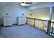 Upstairs loft area with neutral carpet, white cabinets, a skylight and a wood banister at 37 Trotters Run, Brownsburg, IN 46112